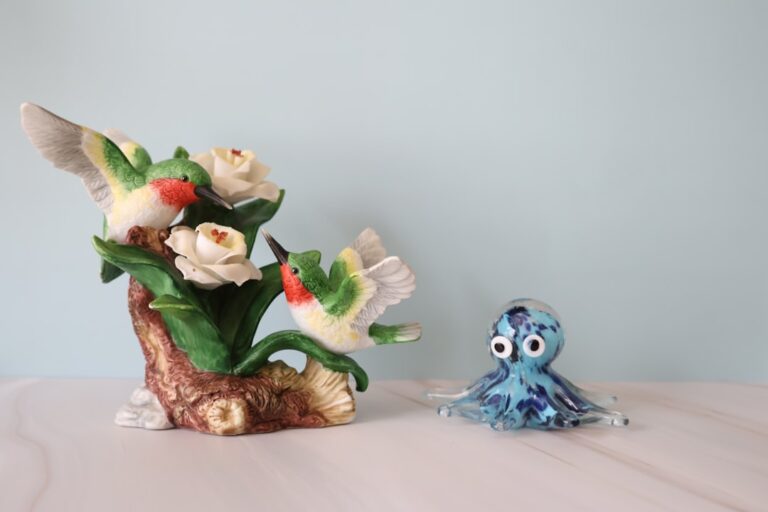 A ceramic hummingbird sculpture paired with a blue glass octopus figurine